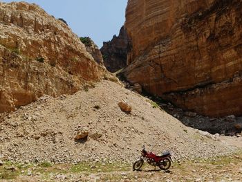 View of horse on rock formation against sky