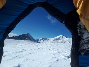 Snowcapped mountains seen from tent against sky