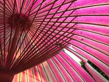 Low angle view of pink umbrella