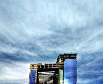 Low angle view of building against cloudy sky