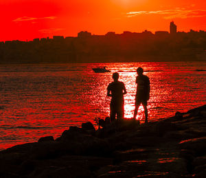 Silhouette of people at sunset