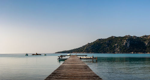 Pier over sea against clear sky