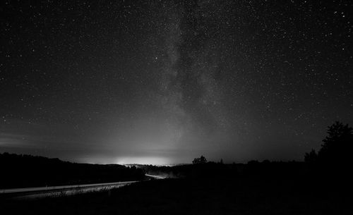 Scenic view of silhouette landscape against star field at night