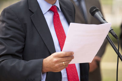 Midsection of businessman giving speech