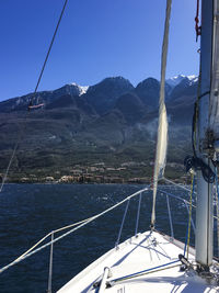 Sailboat sailing in sea against clear sky