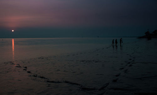 Scenic view of sea against sky at sunset