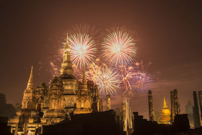 Low angle view of firework display against sky at night