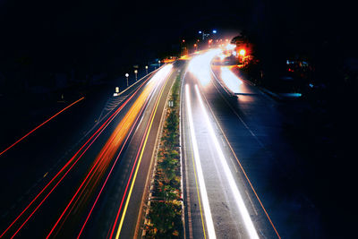 High angle view of light trails on highway at night