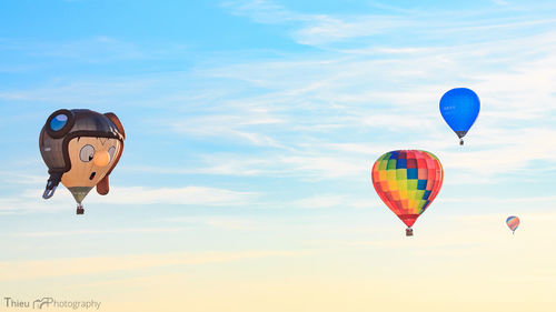 Low angle view of parachute against blue sky