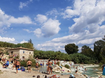 Group of people on beach against sky