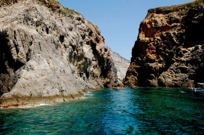 Scenic view of sea and rocks against sky