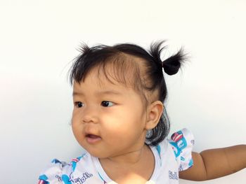 Portrait of cute baby against white background