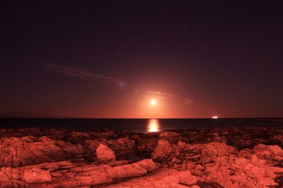 Scenic view of rock formation against sky at night