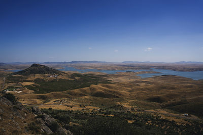 Scenic view of landscape against blue sky