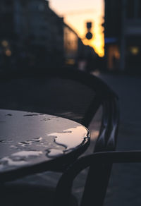 Close-up of car on street at sunset