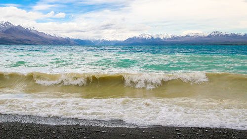 Scenic view of wave rushing towards beach