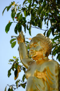 Low angle view of statue against trees