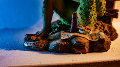 Close-up of old metal container on table