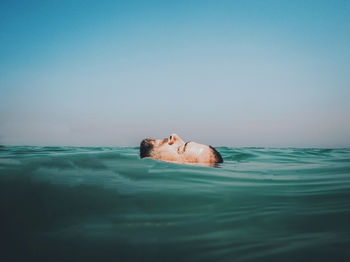 Portrait of person swimming in pool