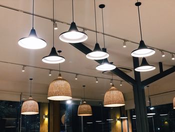 Low angle view of illuminated pendant lights hanging in restaurant