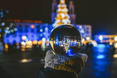 Close-up portrait of illuminated lighting equipment at night