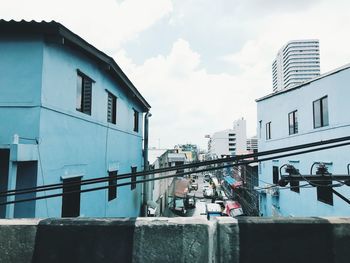 Buildings against cloudy sky
