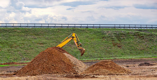 A yellow excavator at work