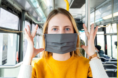 Portrait of woman wearing mask in bus