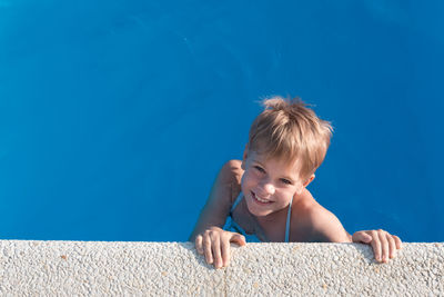 Portrait of cute boy in swimming pool