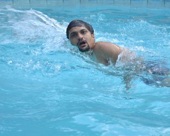 Shirtless man in swimming pool