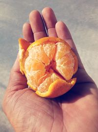 Close-up of hand holding orange