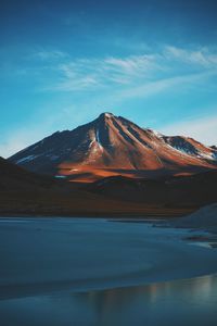 Scenic view of mountains against blue sky