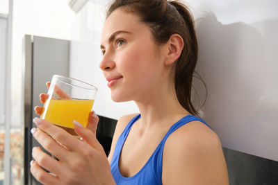 Young woman drinking glass