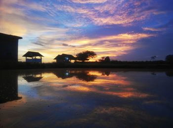 Scenic view of lake at sunset