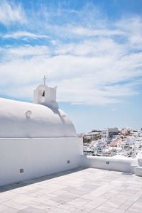 Chapel and buildings against cloudy sky