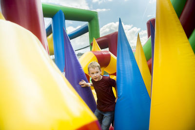Boy playing on colorful bouncy castle