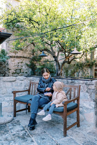 Woman sitting on bench in park