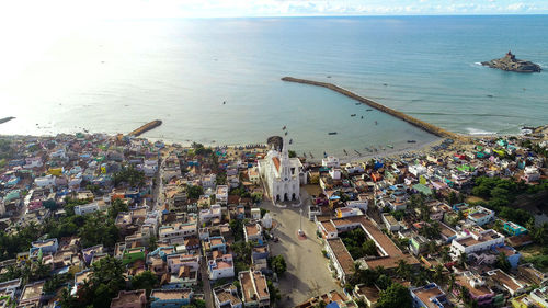 High angle view of townscape by sea against sky