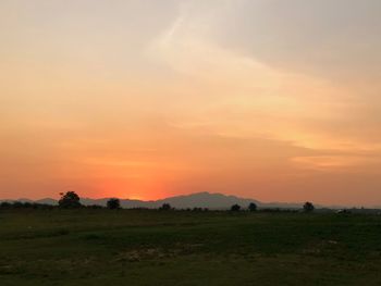 Scenic view of field against sky during sunset