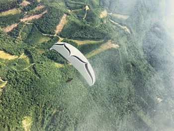 High angle view of helicopter flying over sea