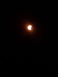 Low angle view of illuminated moon against sky at night