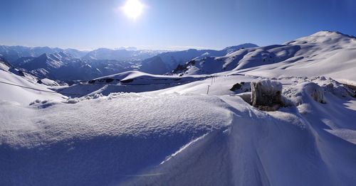 Scenic view of snow covered mountains against sky