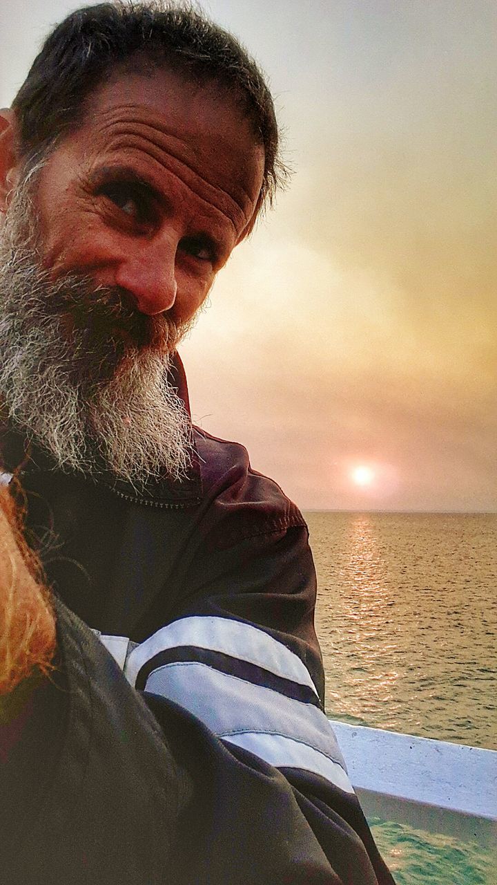 sea, one person, water, beard, real people, beach, horizon over water, leisure activity, nature, outdoors, mature men, scenics, lifestyles, sky, mature adult, beauty in nature, sunset, men, close-up, day, people