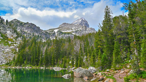 Mountain lake, a rock above the lake in mountains