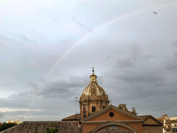Low angle view of rainbow over building