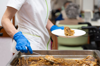 Midsection of man preparing food