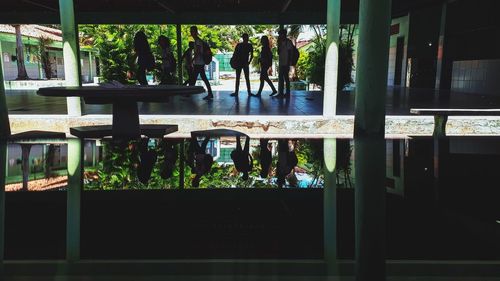 People in restaurant seen through glass window