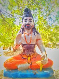 Statue of buddha against trees