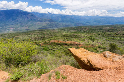 Scenic view of mountains against cloudy sky