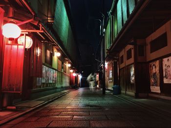 Illuminated walkway at night